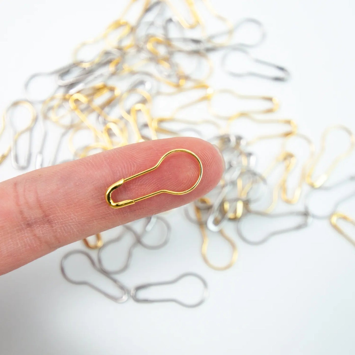 wooden box of metal stitch markers in gold and silver, set of approximately 50 stitch markers